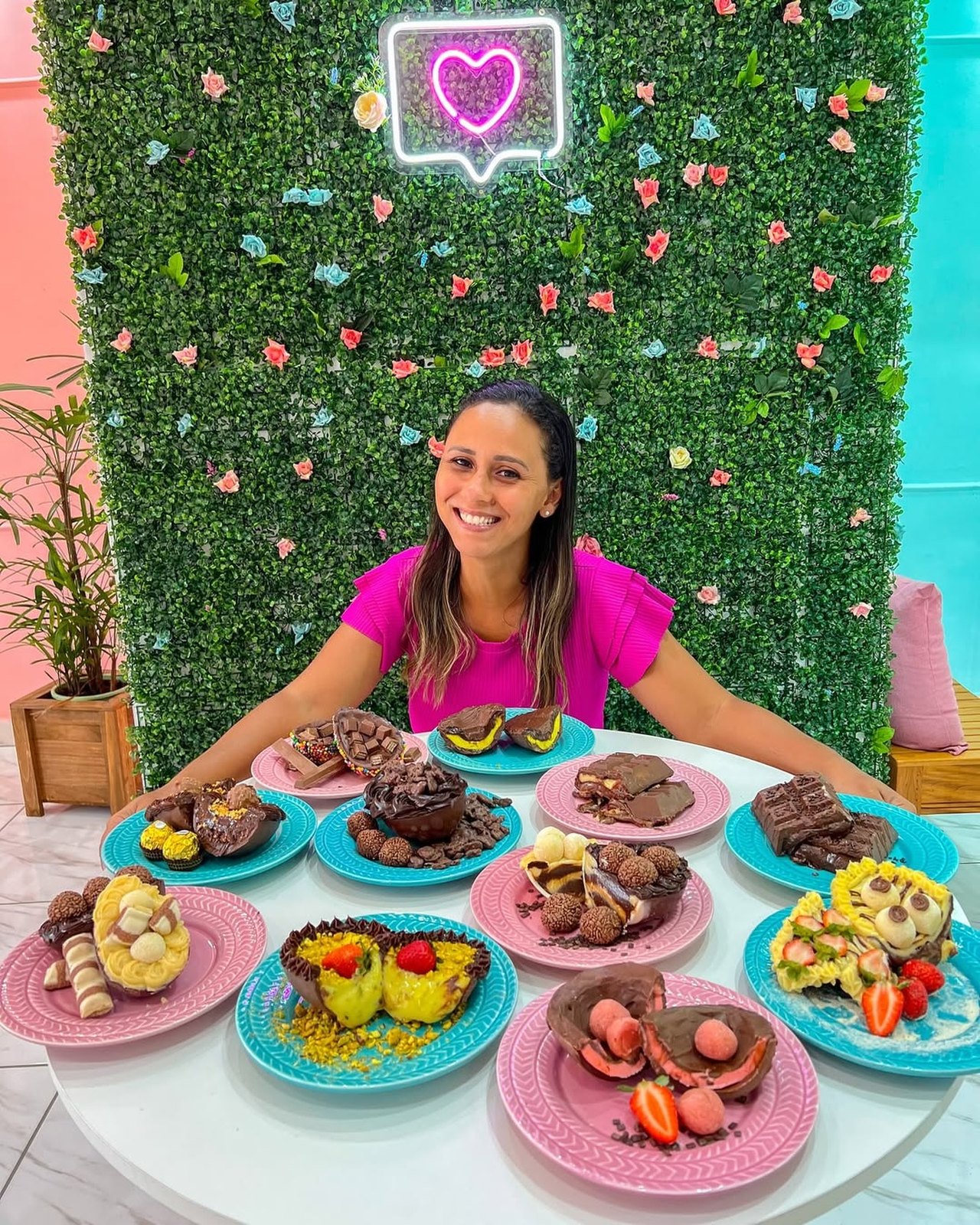 A Débi atrás de uma mesa cheia de doces